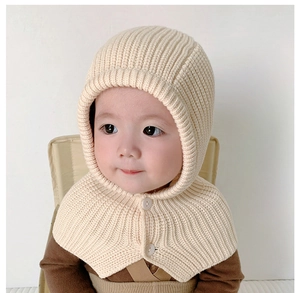 Detail of baby knitted hooded scarf with buttons in cream white color and soft wool texture