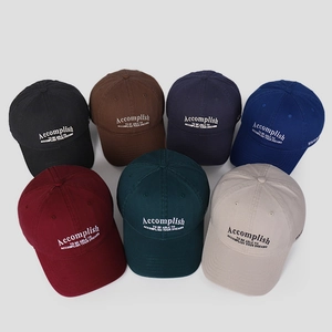 Detailed arrangement of cotton baseball caps in multiple colors with white letter embroidery