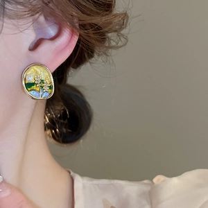 Vue latérale macro de boucles d'oreilles vintage émaillées avec perles sur un mannequin