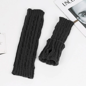 Detailed knit texture of dark grey arm warmers with thumb holes and cable stitch pattern