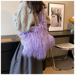 Detail of trendy purple faux fur shoulder bag worn by model in minimalist setting
