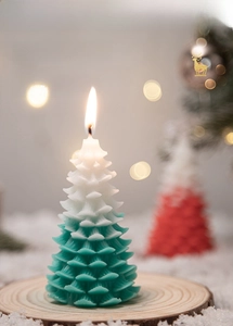 Detailed view of Christmas tree candles in red and gradient green on wooden bases