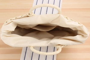 Top view of handmade woven straw bag with cotton lining and interior pocket detail