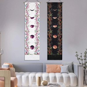 Detailed close-up of Bohemian lunar eclipse phase tapestries with floral patterns and tassels