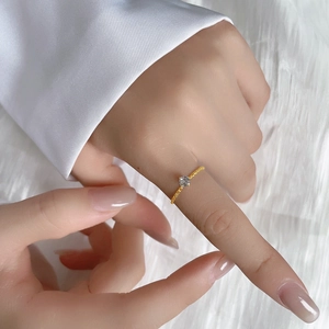Elegant gold titanium steel ring with sparkling solitaire stone and twisted band design