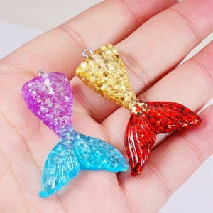 DIY resin mermaid tail pendants in gradient purple-blue and yellow-red with glitter