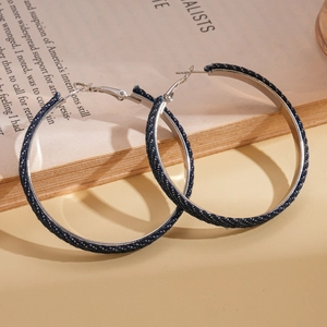 Denim fabric hoop earrings with polka dots on vintage book page, retro fashion style