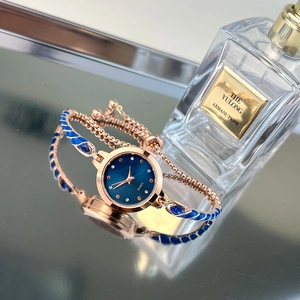 Detailed shot of a rose gold quartz watch with blue enamel bracelet and diamond markers