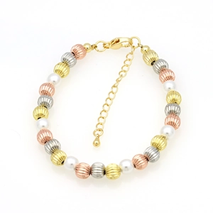 Detailed shot of tri-color metal beads and white pearls bracelet with extension chain
