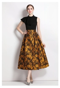 Chic black sleeveless high-neck top with ruffled shoulder and golden jacquard midi skirt