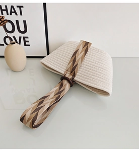 Detail of cotton rope woven tote bag with herringbone pattern strap and wooden ring