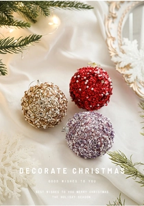 Close-up of three 8cm glitter Christmas balls with red, gold, and purple sequins