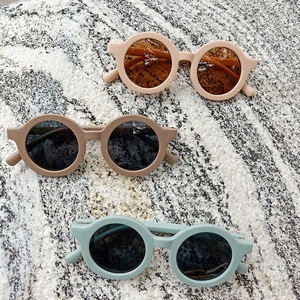 Set of stylish round matte children's sunglasses in beige, brown, and grey blue colors