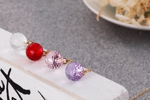 Macro shot of faceted crystal sphere pendants in four colors on fine gold chains