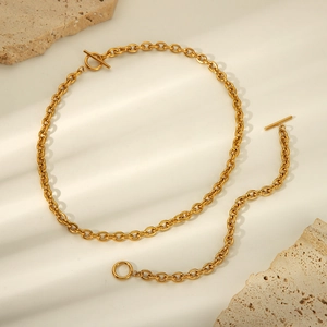 Detailed view of gold stainless steel necklace and bracelet set with stylish OT toggle clasp