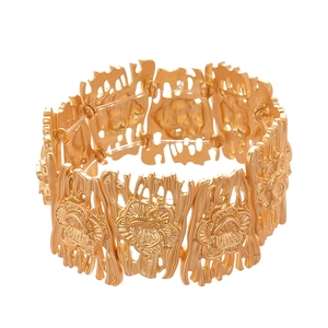 Matte gold wide metal bangle with hollow floral patterns and irregular texture