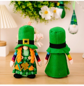 St Patrick Day gnomes detail shot showing green plush doll with orange braids and clover.