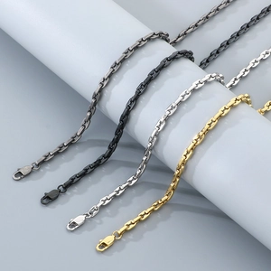 Close-up of interlocking coffee bean link necklaces in black, gunmetal, silver and gold