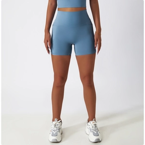 Close-up of light blue high-waisted yoga shorts with side pocket and matte texture