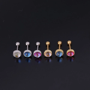 Macro detail of silver and gold moonstone stud earrings with screw ball back on black background