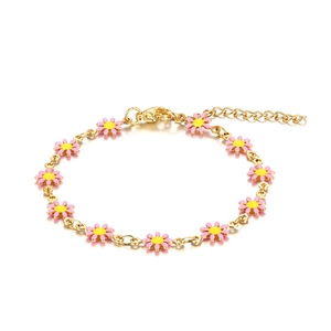 Detail of pink enamel daisy flower charms on adjustable golden 18K titanium steel bracelet