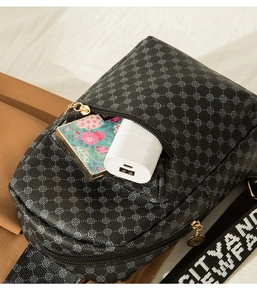 Detail of black chest bag with vintage floral print and CITY FASHION wide nylon strap