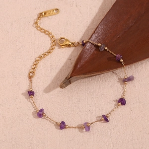 Close-up of 18K gold-plated chain with purple amethyst stones and K18 hallmark tag