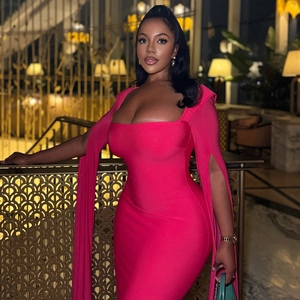 Detail of fuchsia bodycon knit dress featuring dramatic split sleeve streamers and square neck