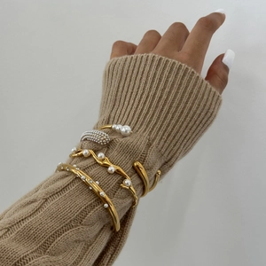 Set of stacked gold stainless steel open bracelets with pearls and sparkling crystals
