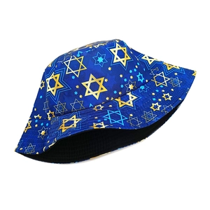 Detailed view of bucket hat featuring navy blue canvas and gold hexagram star patterns