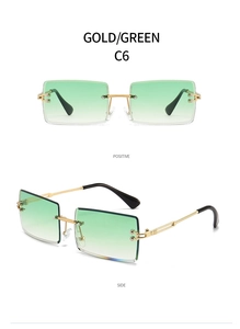 Close-up of frameless rectangle sunglasses with gold metal temples and green gradient lenses