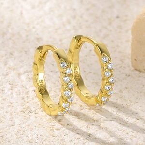 Macro shot of S925 sterling silver gold hoop earrings with sparkling pave zircon stones