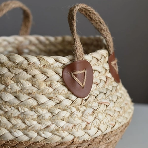 Natural straw woven storage basket with sturdy hemp rope handles and leather accents