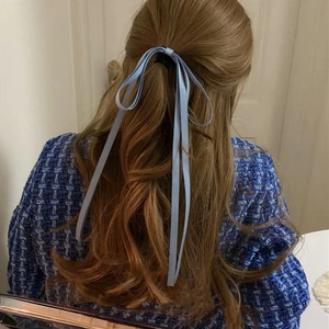 Elegant light blue bow hair ribbon worn by model for a minimalist aesthetic style