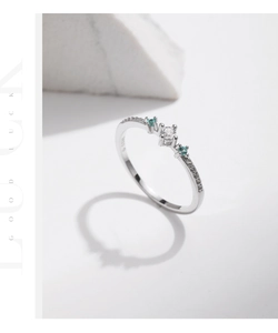Close-up of S925 silver ring featuring blue and white zircon accents on stone background