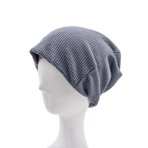 Detailed waffle knit texture on a dark grey slouchy beanie cap for winter