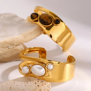 Luxurious gold wide open bangles with hollow design and natural stones on raw stones