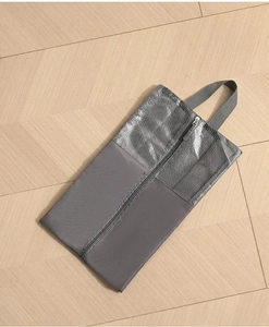 Detail of dark grey travel shoe bag with breathable mesh and reinforced top handle