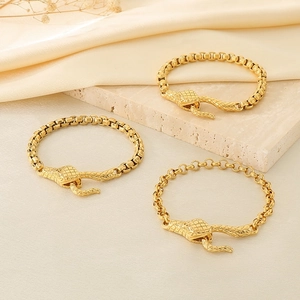 Gold stainless steel snake head clasp pearl bracelets on elegant silk background
