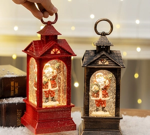 Close-up of vintage Christmas lanterns with Santa Claus figurines and swirling glitter snow