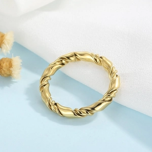 Macro shot of minimalist gold twisted rope ring with elegant double-layer woven details