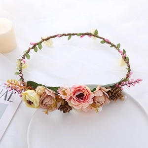 Detail of pink and beige rose crown with green leaves on a white background