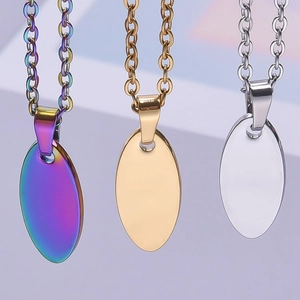 Detailed view of polished oval pendants in gold, silver, and rainbow 18k plated finishes