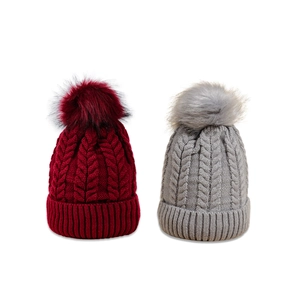 Chunky cable knit beanies with fluffy pom poms in burgundy and grey colors