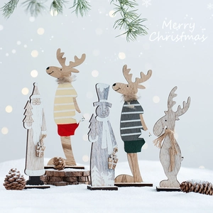 Wooden Christmas table decorations set with reindeer, Santa, and snowmen on snow