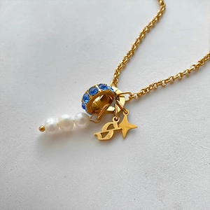 14K gold plated titanium steel necklace with pearls, blue rhinestones and star charms.