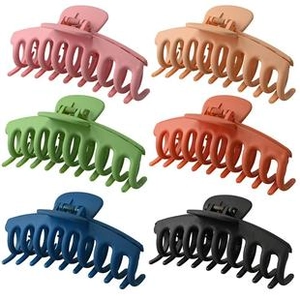 Close-up of six large matte hair claws in pink, beige, green, orange, blue, and black