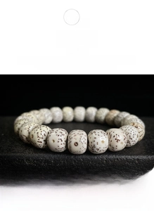 Detailed view of polished Star and Moon Bodhi seed beads with natural spotted texture