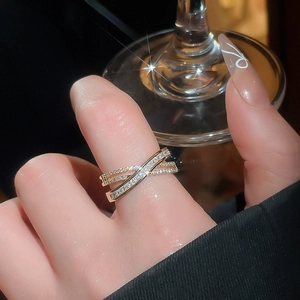 Macro shot of 18k gold plated criss-cross X ring with pave set sparkling cubic zirconia stones