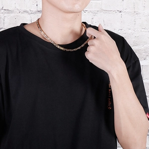 Detailed view of bicolor silver and gold Byzantine chain necklace on a male model